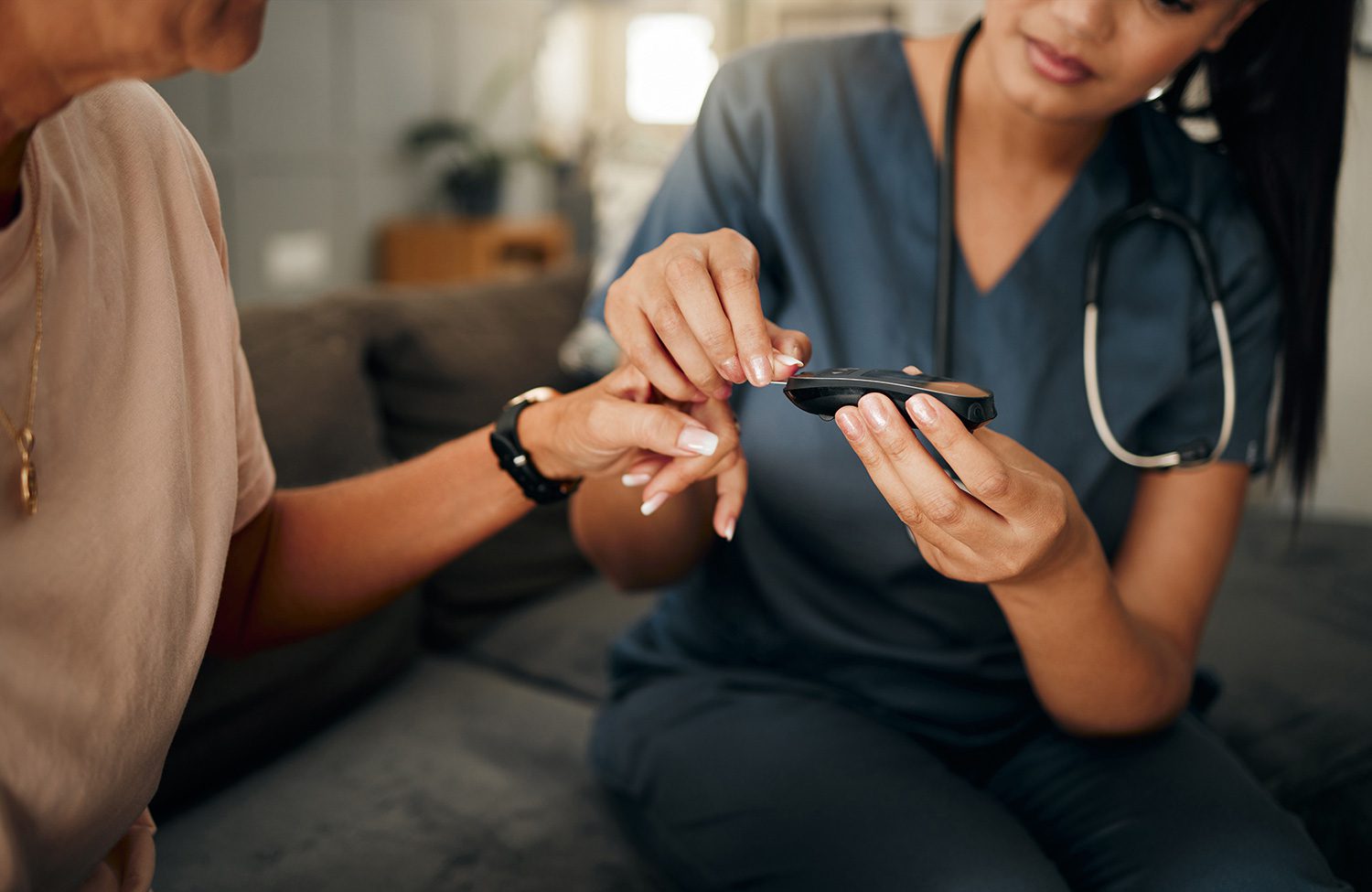 Home Health Nurse Using Glucose Meter